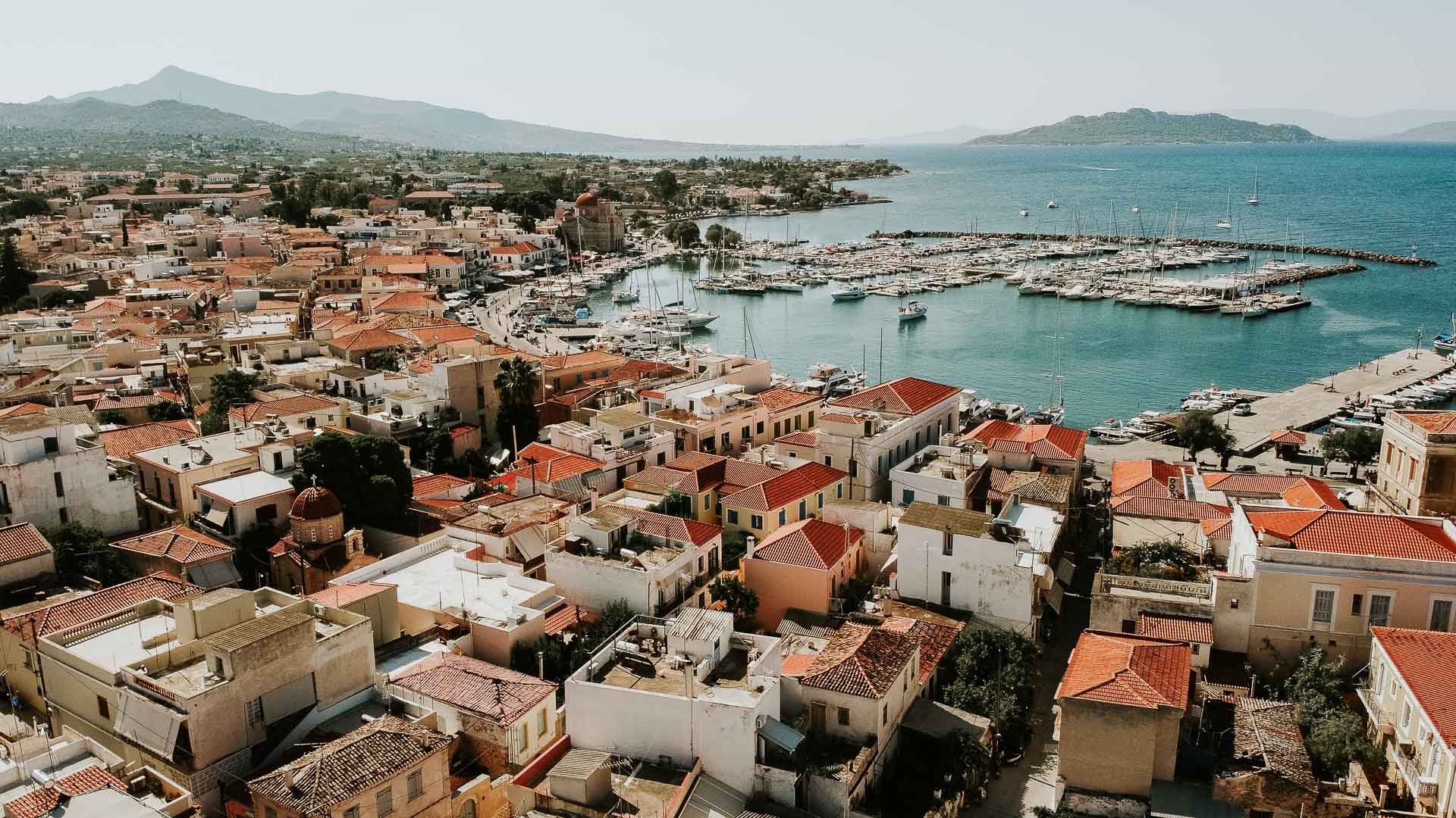 Aerial View of Port Aegina With Luxury Yachts and sailing boats parking on shore.Cityscape wide view over Aegina Island.