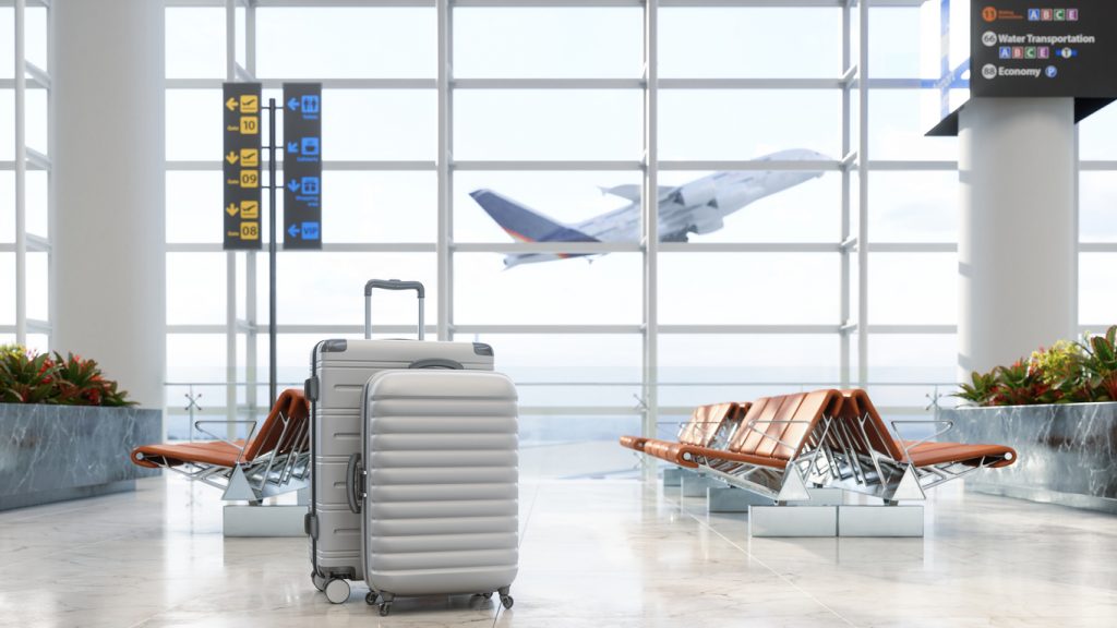 Airport Waiting Area With Luggages, Empty Seats And Blurred Background