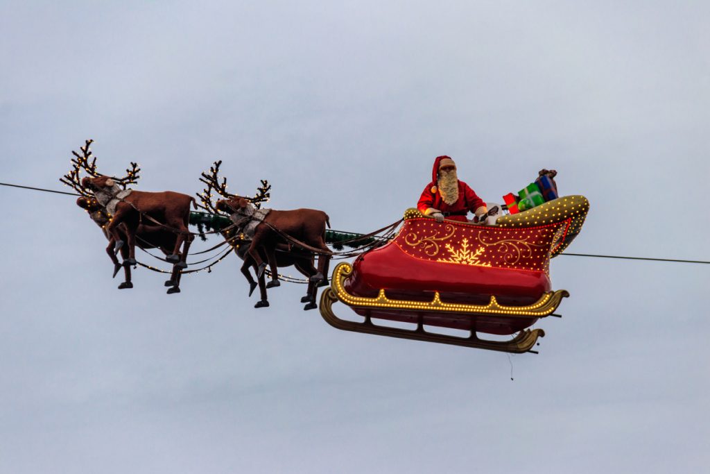 Santa Claus flying in his sleigh pulled by his reindeer during the Christmas market in Montreux, Switzerland