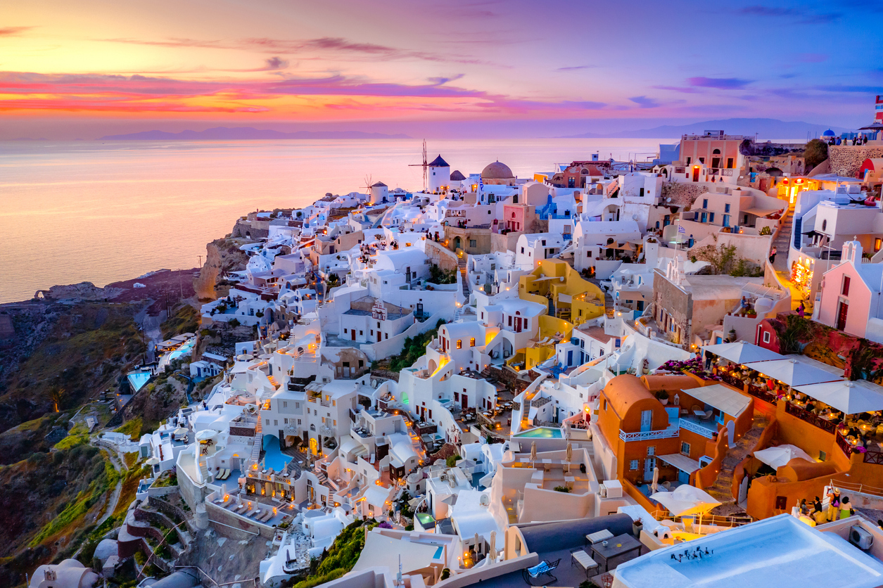 Oia town on Santorini island, Greece. Traditional and famous houses and churches with blue domes over the Caldera, Aegean sea