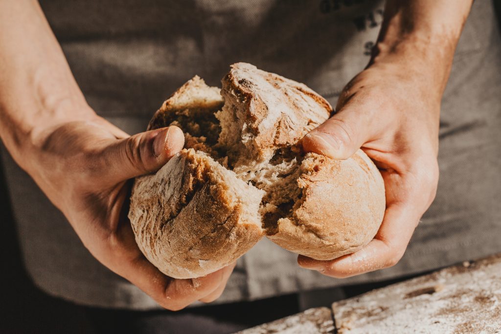 Baker or chef holding fresh made bread