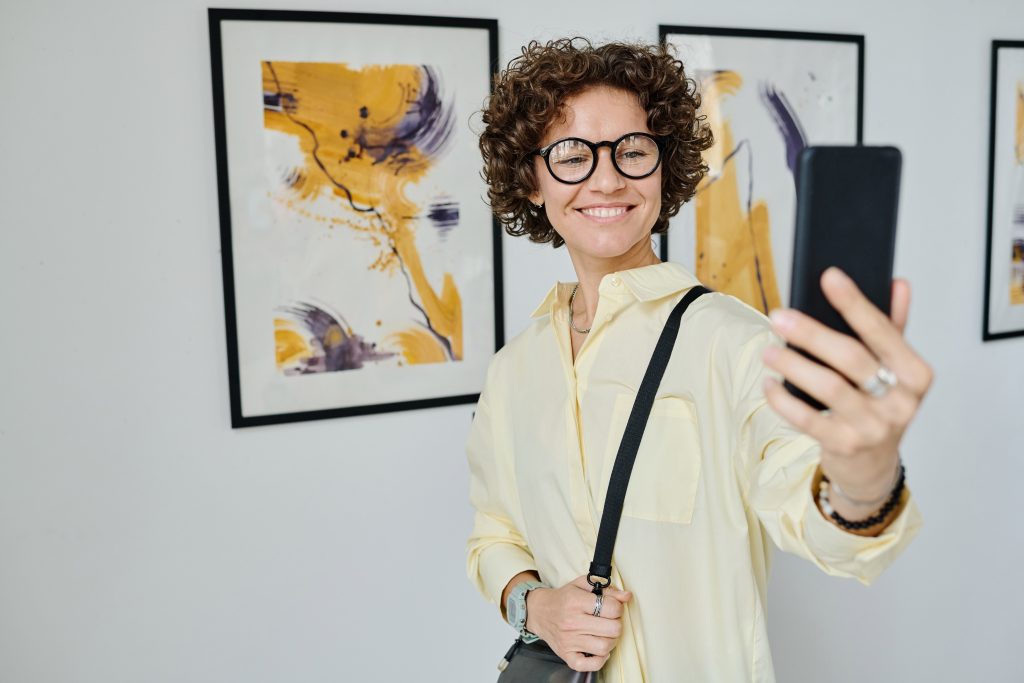 Young woman streaming at art gallery