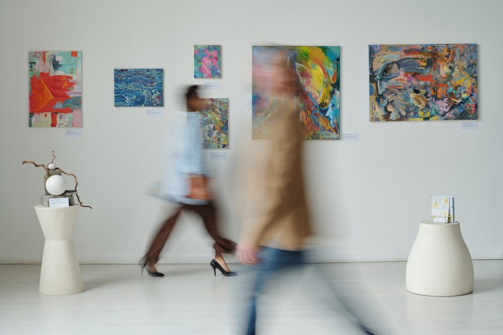 Blurred motion of people visiting art gallery