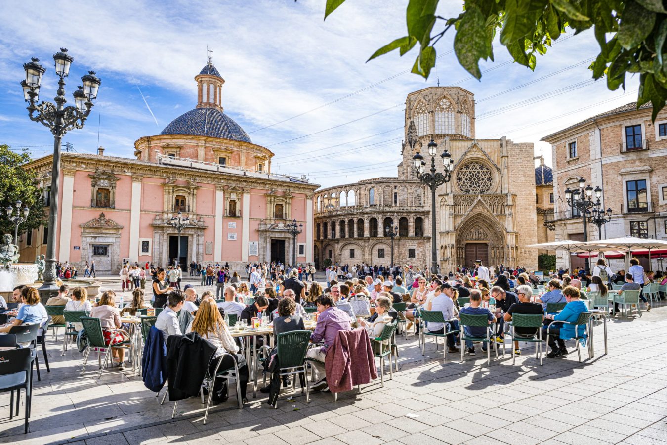 Tourists sitting at street cafe in Valencia, Spain